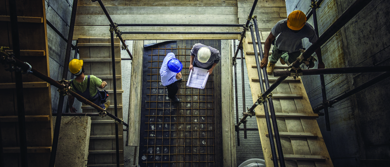 Construction workers and architects viewed from above